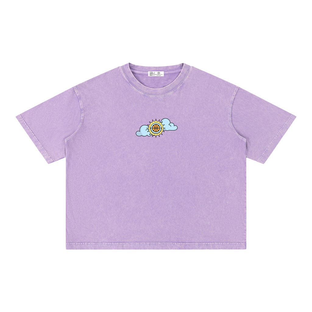 A light purple short-sleeve crewneck t-shirt with a small cartoon sun and cloud graphic on the left chest, displayed flat against a solid white background.